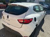 the rear end of a white car parked in a parking lot