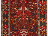 a red and black rug with a floral design on it