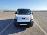 a small white van parked in a parking lot