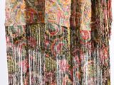 a close up of a multicolored scarf hanging on a clothes rack