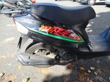 a motor scooter parked on the side of the street