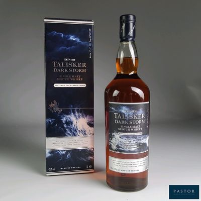 the bottle of talsker dark storm is next to the box