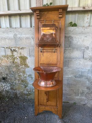 a tall wooden shelf with a bowl on top of it