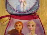 two disney frozen princess purses sitting on top of a wooden floor