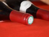 two bottles of wine sitting on a red table