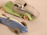 two toy cars sitting next to each other on a table