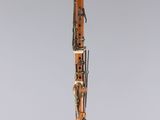 a wooden clarinet with a black and white design on it