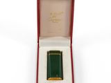 an image of a green lighter in a red box on a white surface