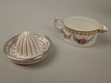 a small bowl and saucer sitting next to each other on a table