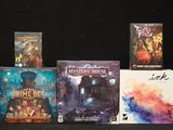 several board games are lined up on a black surface