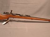 an old rifle with a wooden barrel and a green case