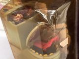 a box with a doll inside of it and a box with a doll inside of it