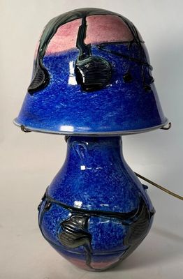 a blue vase with a pink and black design on it