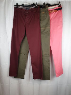three pairs of women ' s pants hanging on a clothes rack
