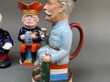 three figurines of men with hats on each of them