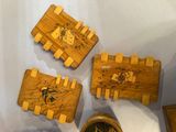 four pieces of wood are arranged on a table with a clock