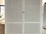 an image of a white cabinet with wicker doors