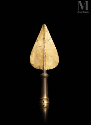 a gold arrow shaped object on a black background