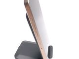 a cell phone that is on a stand on a white surface