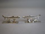 pair of silver plated figurines of a fish and a dog