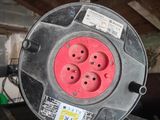 a red and black electrical outlet on top of a black table