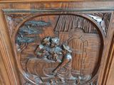 carvings of a man and a woman in a boat on a body of water