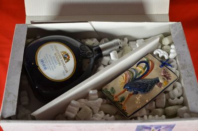 a bottle of liquor and a lighter in a box