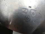 a silver pot with a metal lid on a stove
