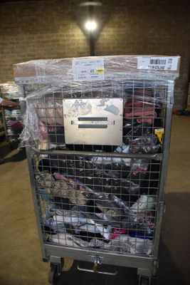 a cart with a lot of shoes on it in a warehouse