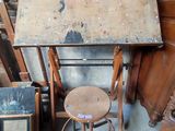 a table with a stool and a mirror on top of it