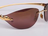 a close up of a pair of sunglasses on a white surface