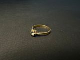a close up of a gold ring on a black surface