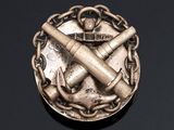 a silver medal with a hammer and anchor on it