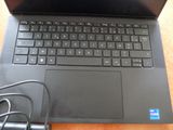 a laptop computer sitting on top of a wooden table