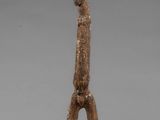 a statue of a man standing on one leg with his hands in the air