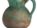a green vase with a handle sitting on a white surface