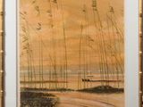 framed picture of a painting of a beach scene with tall grass in the foreground