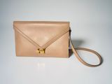 an image of a tan leather envelope bag with a gold clasp