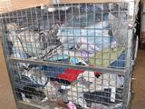 a metal cart with many items in it in a warehouse