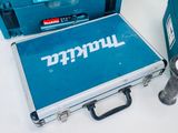 three makit tools sitting on top of a table next to boxes of tools