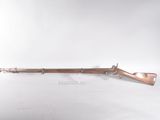 an old rifle on display on a white surface