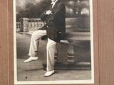 a black and white photo of a man sitting on a bench