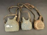 three old purses are lined up in a row on a table