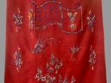an image of a red cloth with a design of birds and flowers