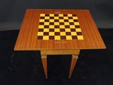 a wooden chess table with a chess board on top