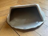 a small white bowl on the floor on the floor