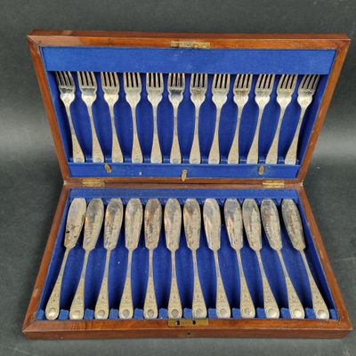 silverware in a wooden case with blue lining on a table