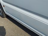 a white van that is parked on the side of the road