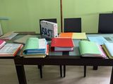 a table with a lot of books and papers on it