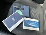 a car seat with a book, sunglasses, and a passport in it